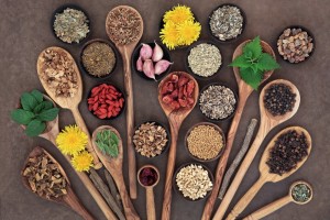 Liver detox super food selection in wooden bowls and spoons over brown paper background..